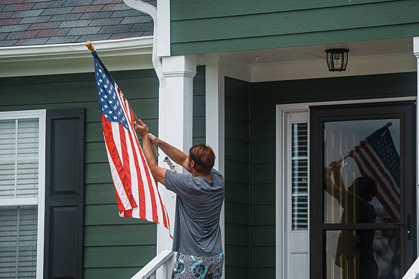 istock Man Raising American Flag on Front Porch 2248253849
