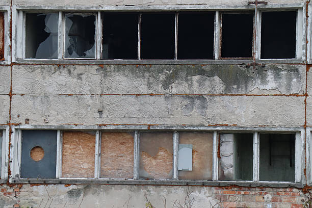 istock Urban Decay Weathered Facade with Broken and Boarded Windows 2248253859