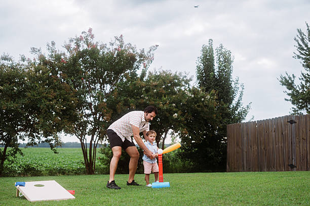 istock Uncle Helping Toddler Practice T-Ball 2248254836