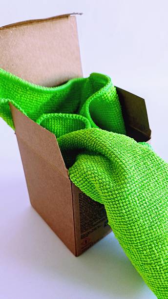 Green kitchen towel in a brown cardboard small box. -
