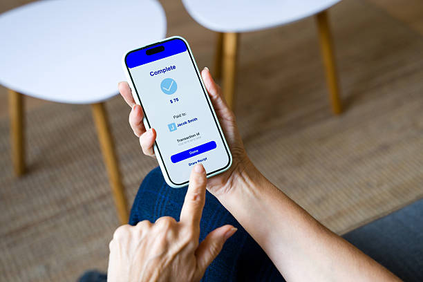 istock Person completing a mobile payment transaction on smartphone 2248259203