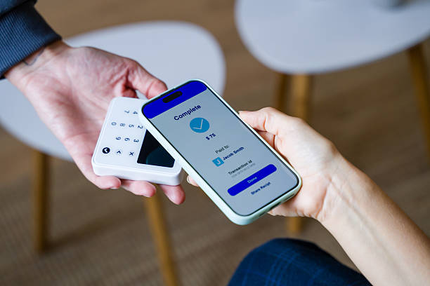 istock Person making contactless payment with smartphone and POS terminal 2248259253