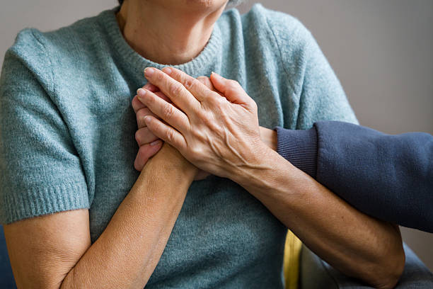 istock Senior adults holding hands expressing support and care 2248259905