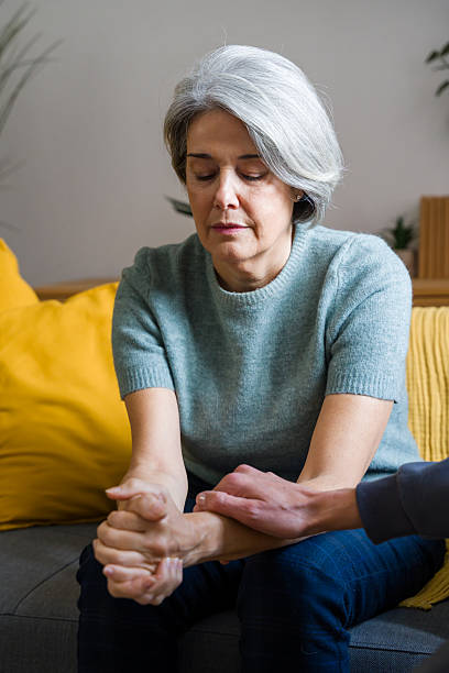istock Mature woman receiving comfort from supporting hand 2248259995