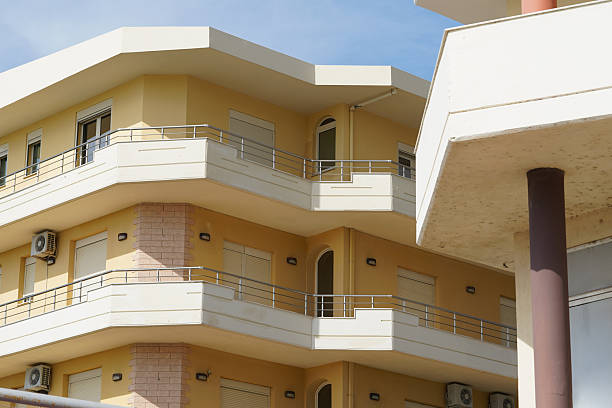istock A plain urban structure with simple railings and old AC units marks a typical coastal street. Great for property investors, apartment renters, and foreigners seeking city housing abroad. 2248262013