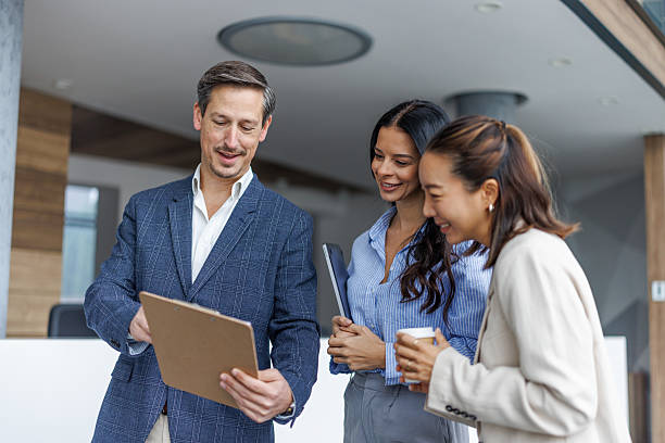istock Business colleagues reviewing documents and discussing work 2248265145