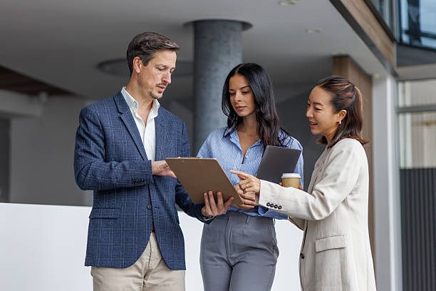 istock Business colleagues reviewing document during office discussion 2248265187