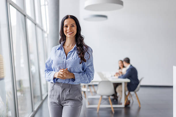 istock Confident businesswoman smiling in modern office environment 2248265273