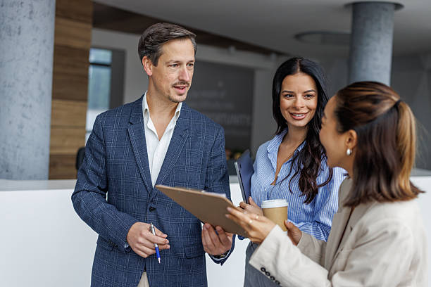 istock Business colleagues collaborating on project documentation in office lobby 2248265276