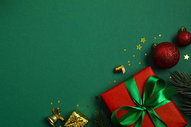 istock Christmas gift box and decorations on green background,  seasonal greeting 2248266684