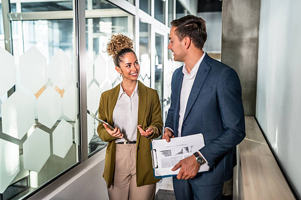 istock Business colleagues talking walking office hallway working together 2248266756