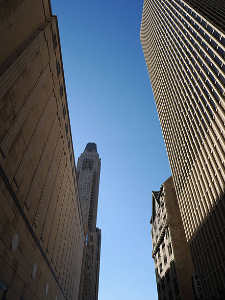 istock Vertical street canyon view contrasting classic stone and vertical grid skyscrapers 2248267472