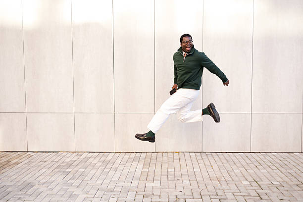 istock Happy man jumping with energy outdoors 2248267832