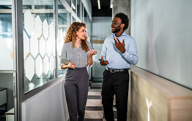 istock Diverse business colleagues walking and talking in office 2248268020