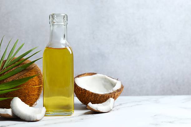 istock Bottle of coconut oil on white table 2248268093