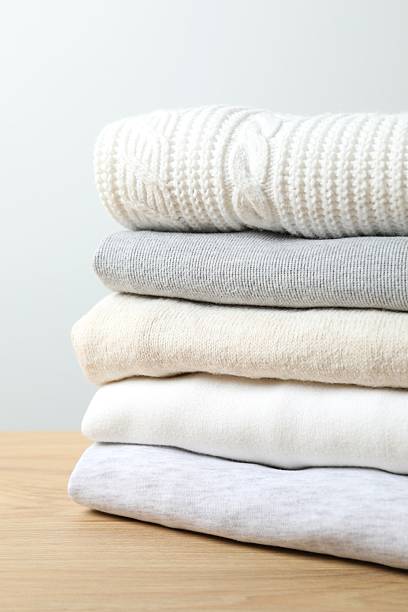 istock Vertical view of stack of perfectly folded clothing items 2248268121