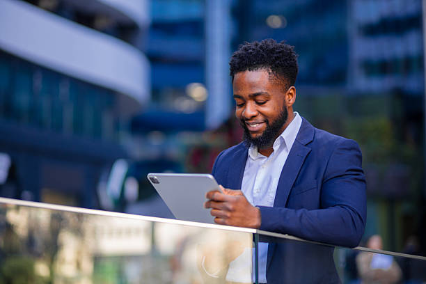 istock Black businessman working on tablet outdoors 2248269935