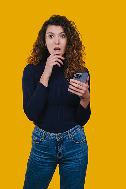 istock woman shows shock upon reading message, person displays surprise while viewing message on camera 2248270617