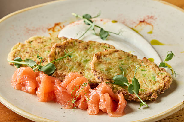 istock delicately arranged zucchini and salmon, artfully crafted dish featuring herbs and microgreens 2248271338
