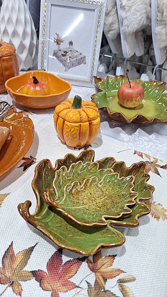 istock Artistic autumn-inspired ceramic dishes and pumpkin-shaped bowls displayed on a decorative table 2248272505