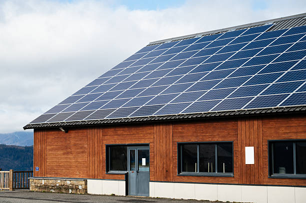 A sustainable warehouse building with wooden facade and solar panels on its rooftop