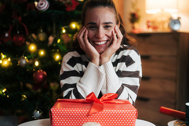 istock Happy woman experiencing christmas joy with gift 2248278262