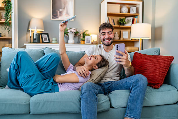 istock Happy couple relaxing watching online video on sofa 2248280152