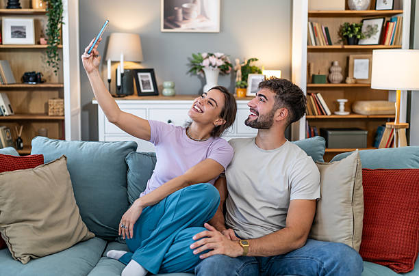 istock Happy young couple taking selfie smartphone on sofa 2248280804