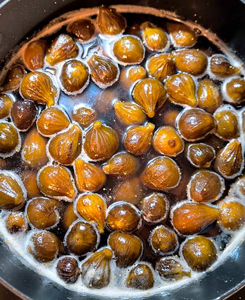 istock Making fig jam, whole ripe figs in hot golden syrup 2248280821