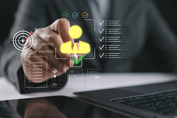 istock Man holding stylus pointing at virtual candidate profile with checklist and approval icons on laptop screen, concept of human resources, recruitment process, employee evaluation and selection system. 2248280834