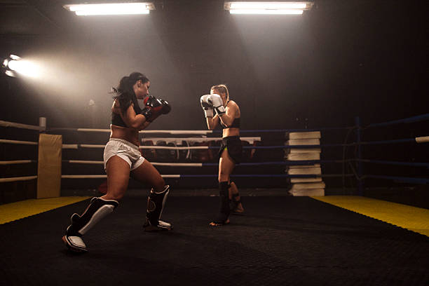 istock Women boxing match in ring under dramatic lights 2248280926