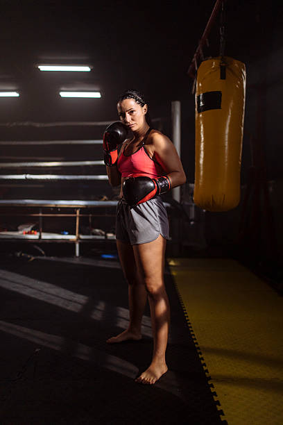 istock Female boxer stands ready in boxing gym 2248280970