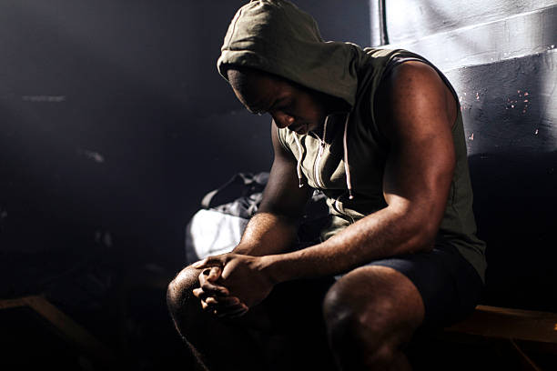 istock Contemplative man resting on bench in hoodie 2248280975
