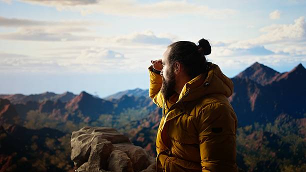 istock Victorious hiker relaxing at the mountain summit after climbing the top 2248281310