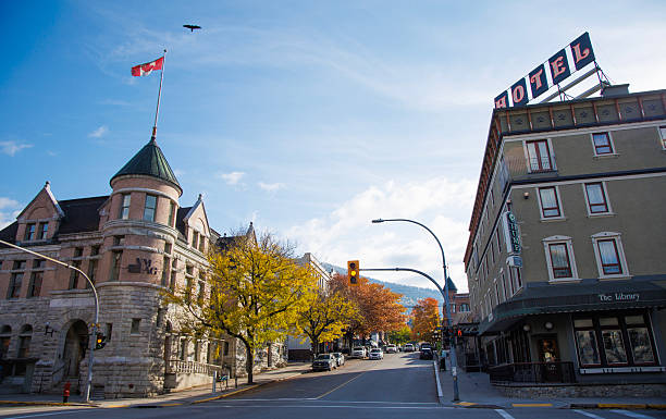 A view of the intersection of Ward and Vernon Streets and the historic downtown of Nelson, British Columbia, Canada, in the fall. From the left is the Nelson Museum, Archives, and Gallery, and on the right is the Hume Hotel.