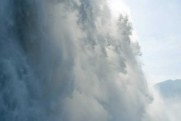 Mist from the Canadian Falls forms a rainbow on a sunny day in Niagara Falls