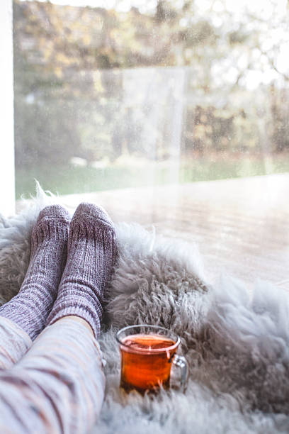 istock Relaxing at home with warm socks and a cup of tea 2248284125