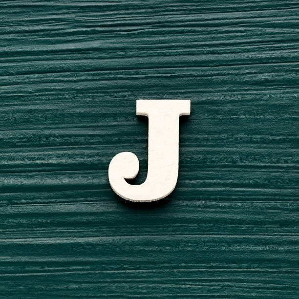 istock Capital letter J, White letter on a rustic dark green background 2248285778