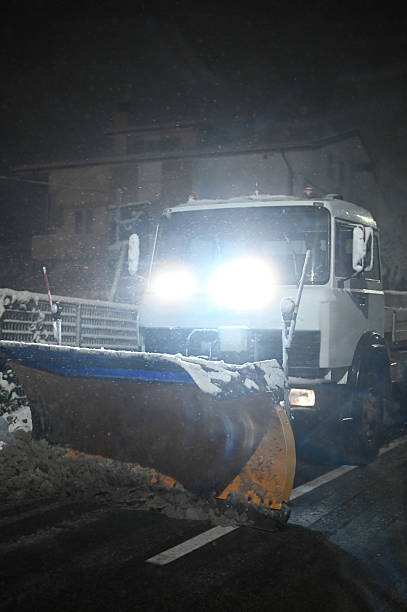 istock Snowplow truck clearing road during winter blizzard at night 2248285932
