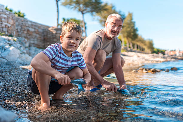 A young caucasian fisherman proudly holds up a stringer of walleyes.