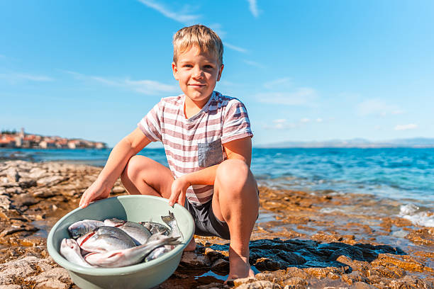 Boy caught a fish. child on the lake fishing