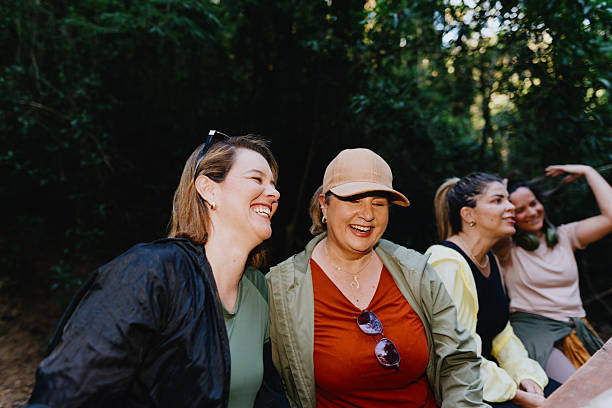 Hikers laughing together on a forest trail break