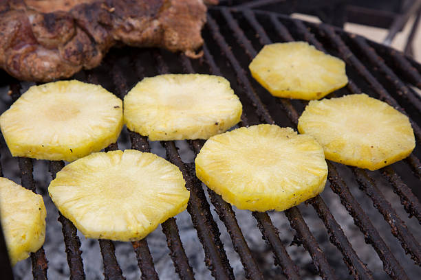 istock slices of pineapple freshly placed on the grill 2248289014