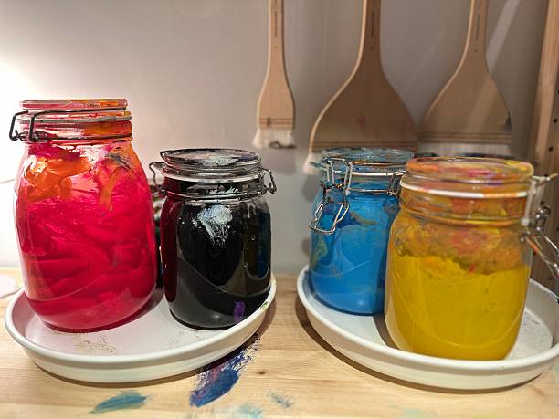 istock Glass jars with bright liquids and pigments on a white surface 2248289193