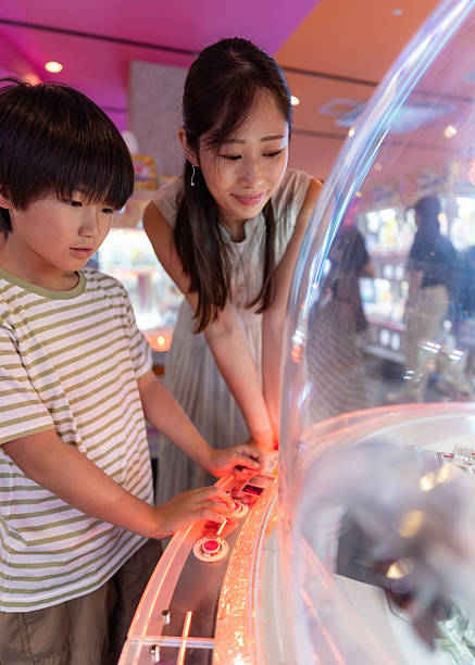 istock Family playing crane game in amusement arcade 2248289647