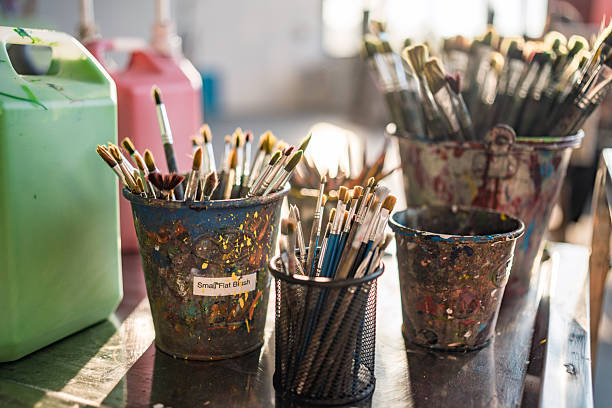 istock Colorful Art Supplies in Sunlit Studio with Paintbrushes in Rustic Containers 2248289838