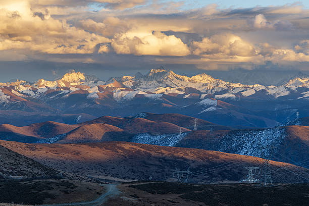 istock Golden Clouds Over Snowy Range with power lines crossing the mountains 2248293170