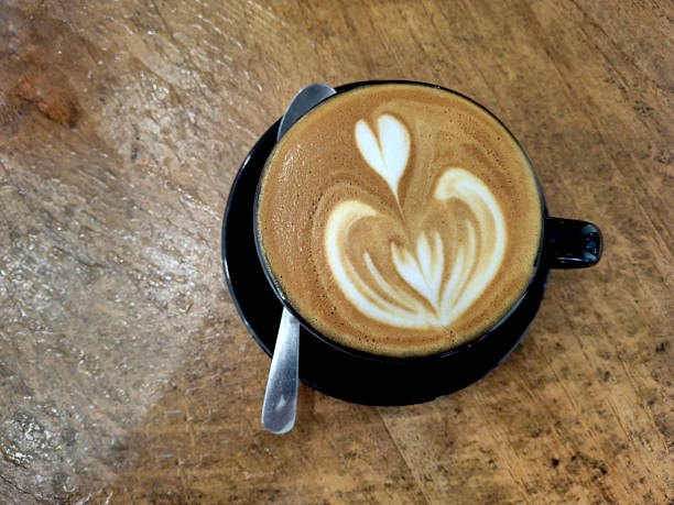 Morning Coffee with Beautiful Latte Art on Rustic Wood