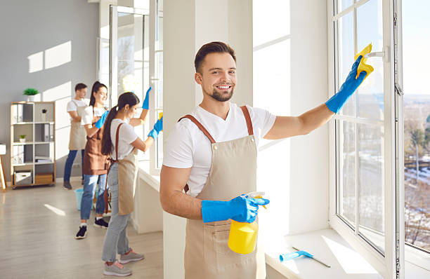 istock Team of happy cleaning service workers washing office windows on sunny spring day 2248294361