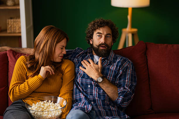 istock Scared couple watching a horror movie at home. 2248295267